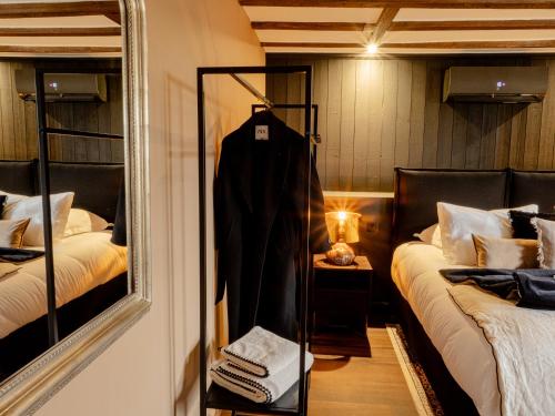 a mirror in a room with two beds at La Longère de Bourgogne in Demigny