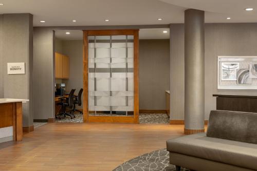 a lobby with a door and a table with chairs at SpringHill Suites by Marriott Wisconsin Dells in Wisconsin Dells