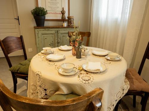 a dining room table with a white table cloth on it at La Longère de Bourgogne in Demigny
