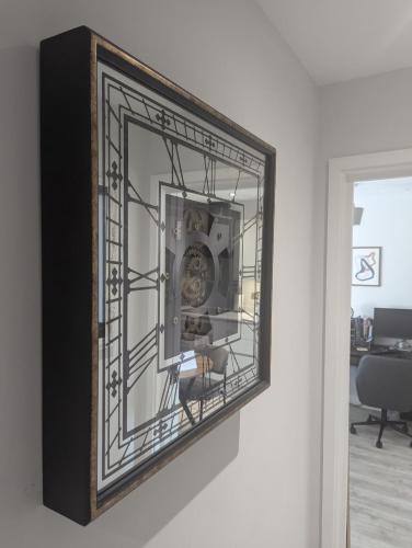 a mirror hanging on a wall in a room at Stylish Harbourside Apartment in Bristol