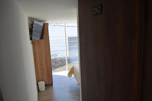 an open door with a view of a room with a window at Hotel Diamond Luxury Tunja in Tunja