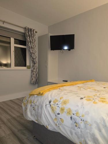 a bedroom with a bed with a tv on the wall at Cuas view in Dingle