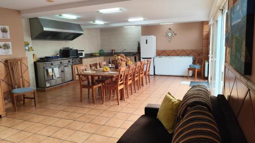 a kitchen and dining room with a table and a refrigerator at Winahost Naveces La Bahía in OVD