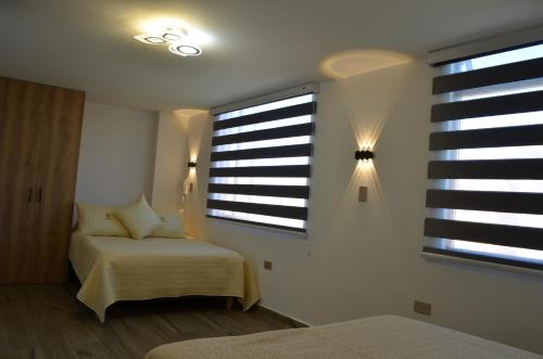 a bedroom with a bed and a window at Hotel Diamond Luxury Tunja in Tunja