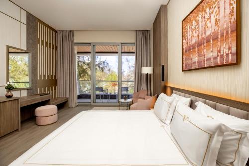 a hotel room with a bed and a desk at Rixos Montaza Alexandria in Alexandria
