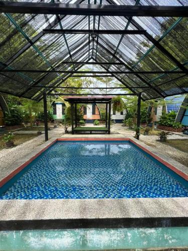 a large swimming pool under a roof at BungaVilla Chalet in Port Dickson