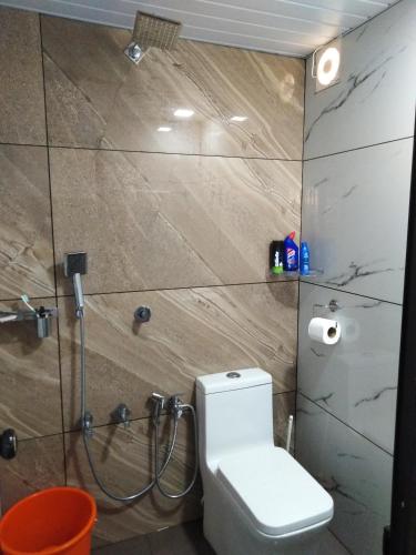a bathroom with a toilet and a shower at Pepper Mist Wayanad Homestay in Tindummal