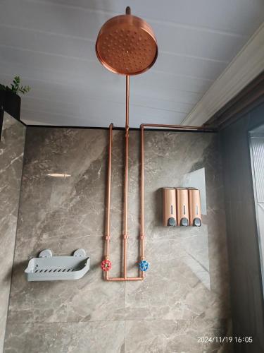 a light hanging from the ceiling in a room at Polka Dot Airport Exec Suite in Kempton Park