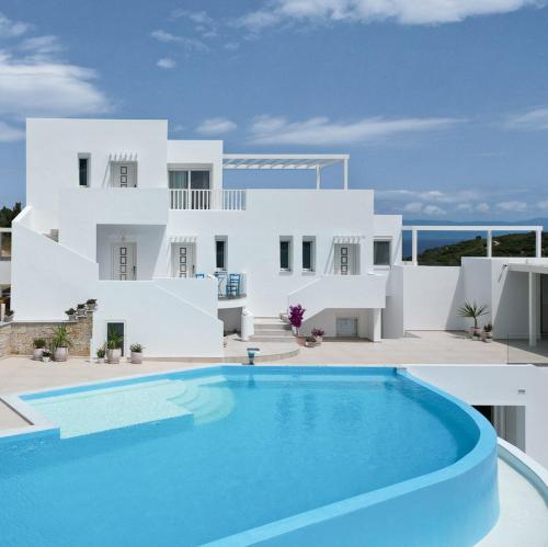 a villa with a swimming pool in front of a house at Cavo del Sol in Sarti