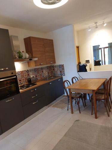 a kitchen with a wooden table and a dining room at La mia Casa a Talamone in Talamone