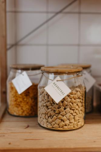 three jars filled with nuts sitting on a table at Vassbo Vandrarhem in Falun