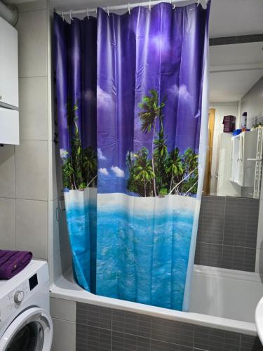 a shower curtain with a view of the ocean at APARTMAN LIDER Zagreb Free Parking 2 Bedrooms 54 m2 Self Check-in in Zagreb