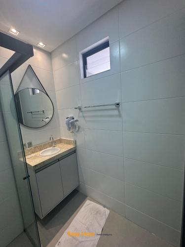 a bathroom with a sink and a mirror at Flats Tramonto - By EasyHost in João Pessoa