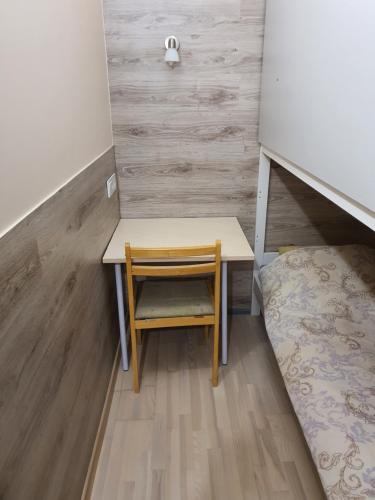 a small desk with a chair in a room at Tokyo Vibes - Private Sleeping Pods Hostel, Self check-in in Vilnius