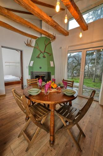 a dining room with a table and a fireplace at Пе́трови Вили in Ribarica