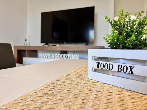 a wood box sitting on top of a table with a tv at La rocca - private Garden in Darfo