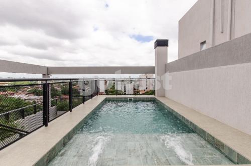 a swimming pool on the balcony of a building at Luxe 2 Bedroom Apt In The Heart Of Villa Morra in Asuncion