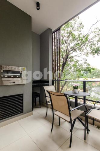 a living room with a fireplace and a table and chairs at Luxe 2 Bedroom Apt In The Heart Of Villa Morra in Asuncion