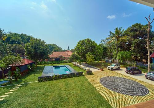 an aerial view of a house with a swimming pool at VOYE HOMES Signature Pool Resort Varkala , Just 950 m from Varkala Cliff and Beach in Varkala