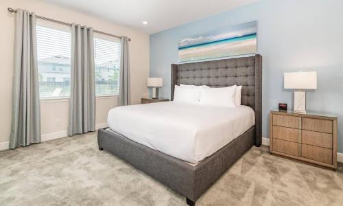 a bedroom with a large bed and a window at Captivating 5 Bdrm Villa with Theater at Encore in Orlando
