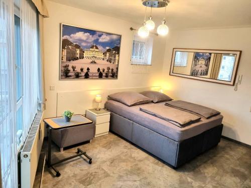 a bedroom with a bed and a picture on the wall at Ludwig Apartment in Ludwigsburg