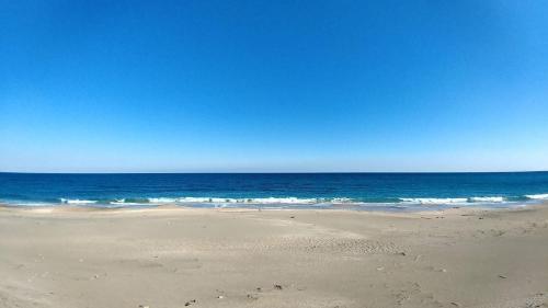 a sandy beach with the ocean in the background at Villent Kujukuri Ocean 2 in Kujukuri