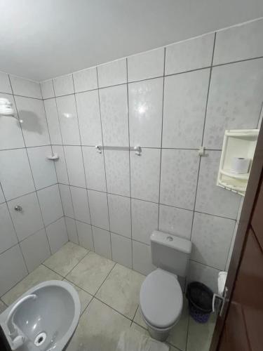 a bathroom with a toilet and a sink at Villa Brilho do Sol Jeri in Jericoacoara
