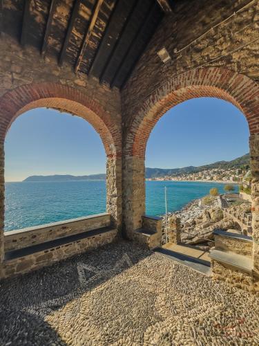 a view of the ocean from a building with two windows at Ceriale for Fun - AquaPark & Beaches 5min - AC in Ceriale