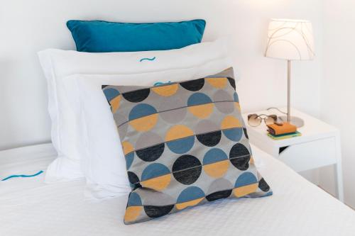a white bed with a pillow on it at Beachouse - Surf, Bed & Breakfast in Ericeira