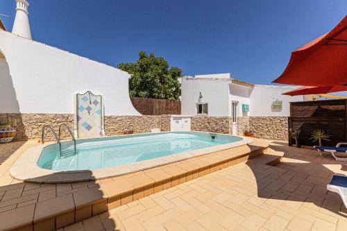 a swimming pool in the middle of a patio at Chilling In Lagos House Retreat by Algarve Golden Properties in Lagos
