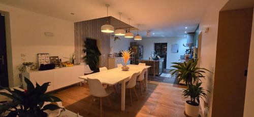 a kitchen and dining room with a table and chairs at Papillon 05 - Wellness in Briançon