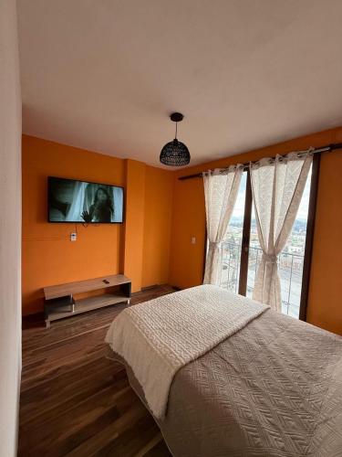 a bedroom with a bed and a large window at Metepec in Toluca