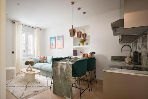 a kitchen and living room with a couch and a table at Le XV Cannes in Cannes