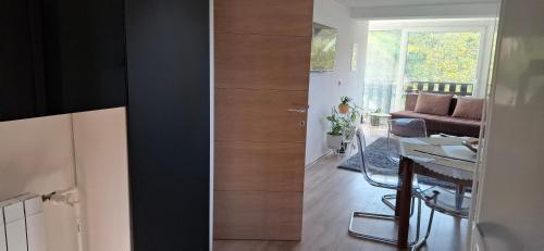 a room with a door and a dining room with a table at Vila Jovana in Vrdnik