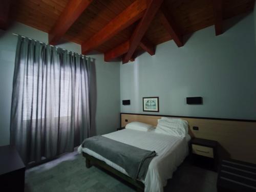 a bedroom with a bed and a large window at Hotel Quadrifoglio in Pontecagnano