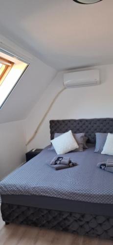 a bedroom with a bed with two shoes on it at Vila Jovana in Vrdnik