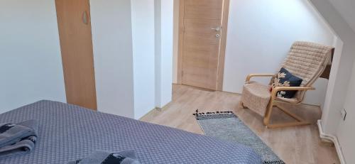 a bedroom with a bed and a chair and a rug at Vila Jovana in Vrdnik
