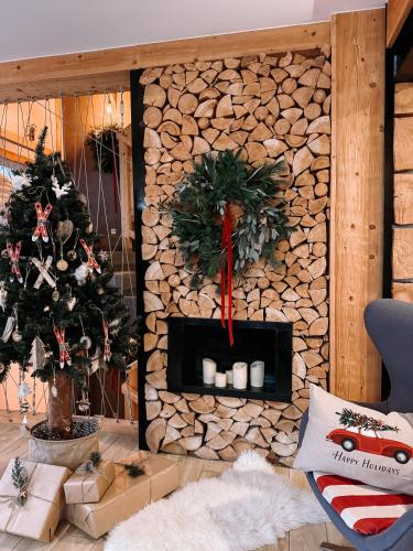 a living room with a christmas tree and a fireplace at Villa 11 Folk & Design in Zakopane