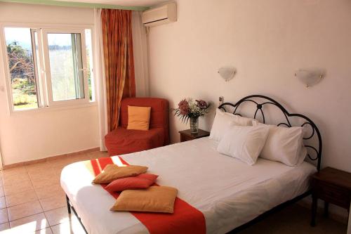 a bedroom with a bed with two towels on it at Rigas Apartments in Skiathos Town