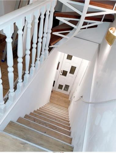 a staircase in a house with white railings at Burano Cà Comare in Burano