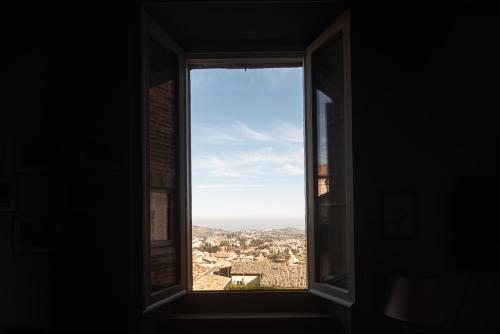 an open window with a view of a city at Palazzo Capparucci - Dimora storica in Fermo