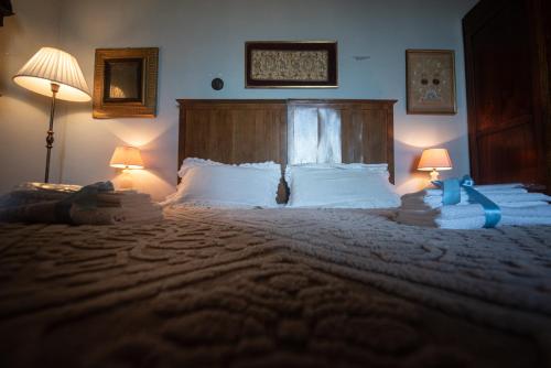 a bedroom with a large bed with two lamps at Palazzo Capparucci - Dimora storica in Fermo