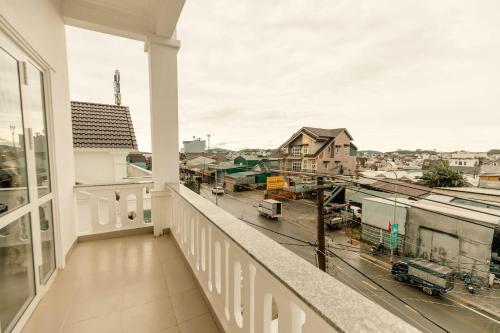 a balcony with a view of a city at Lê Mùi Hotel - Apartment in Da Thien
