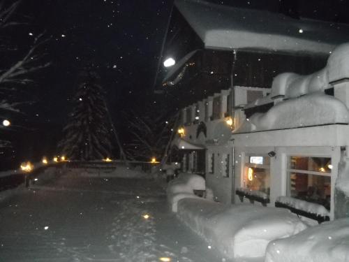 a building covered in snow at night at Pension U Jelinka in Nové Hamry