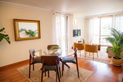 a dining room with a glass table and chairs at Madeira Precious Penthouse in Funchal