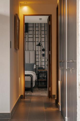 a hallway leading to a bedroom with a bed in it at Maison Italia 1029 in Santiago