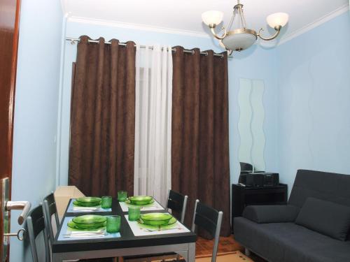 a living room with a table and a couch at Faria Guimares Porto Centro in Porto