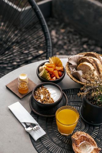 a table topped with bowls of food and bread at Maison Italia 1029 in Santiago