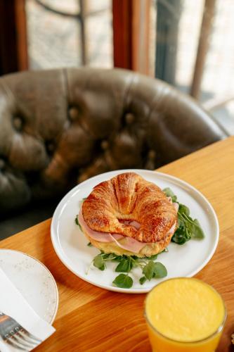 a croissant sandwich on a plate on a table at Maison Italia 1029 in Santiago