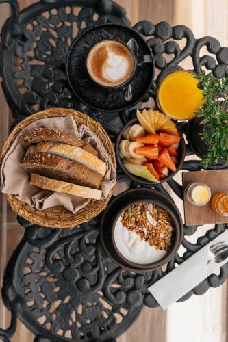 a table topped with bowls of breakfast foods and coffee at Maison Italia 1029 in Santiago